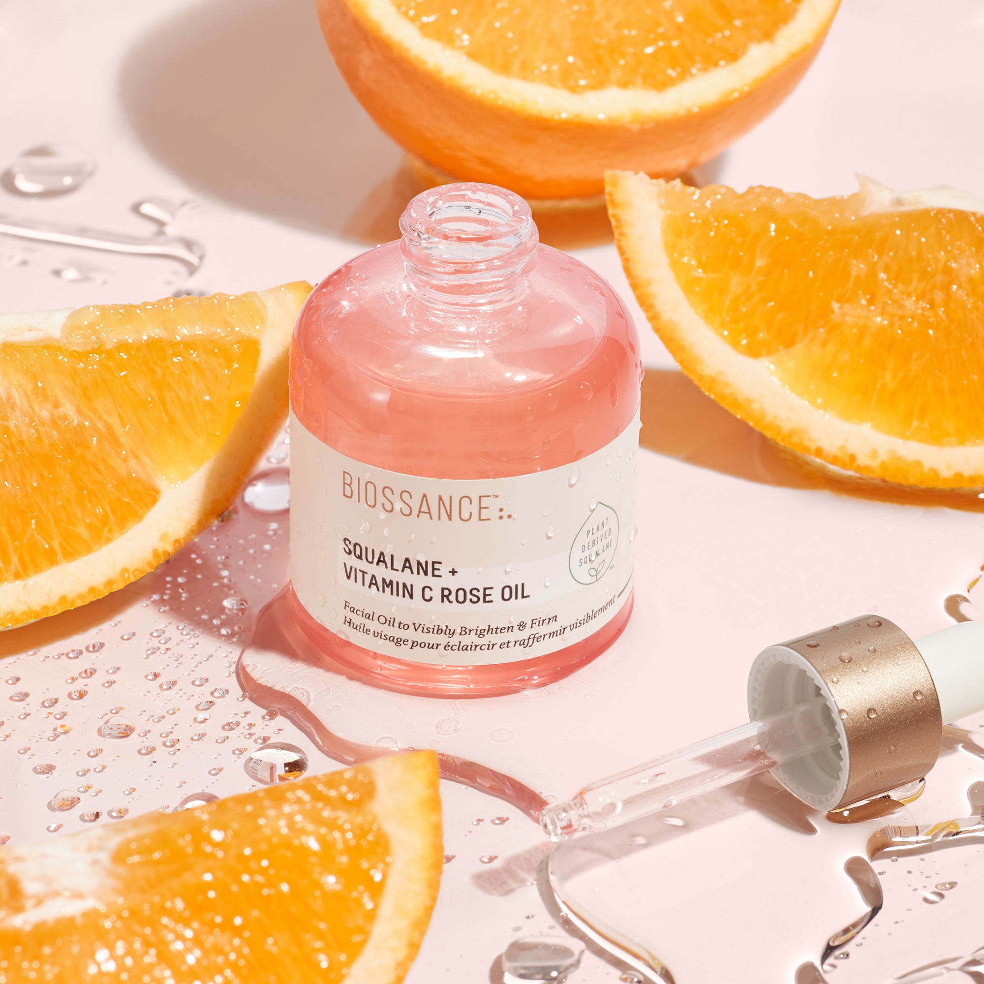 Biossance Squalane + Vitamin C Rose Oil surrounded by orange slices