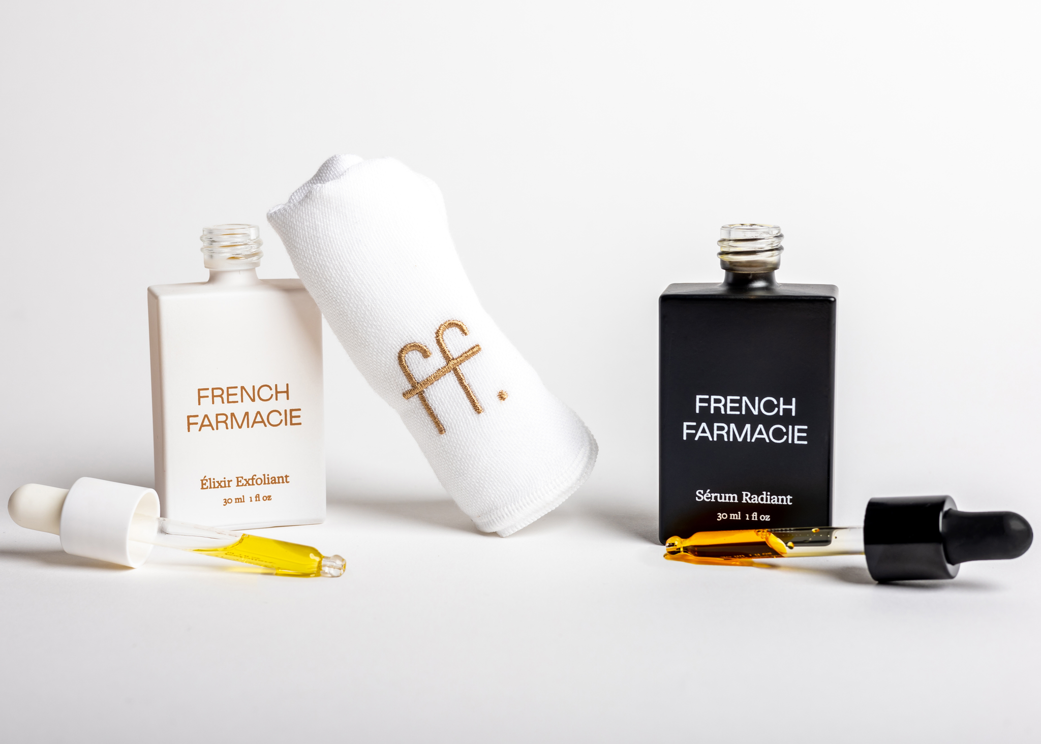 French Farmacie's Élixir Exfoliant and Sérum Radiant with droppers and branded towel