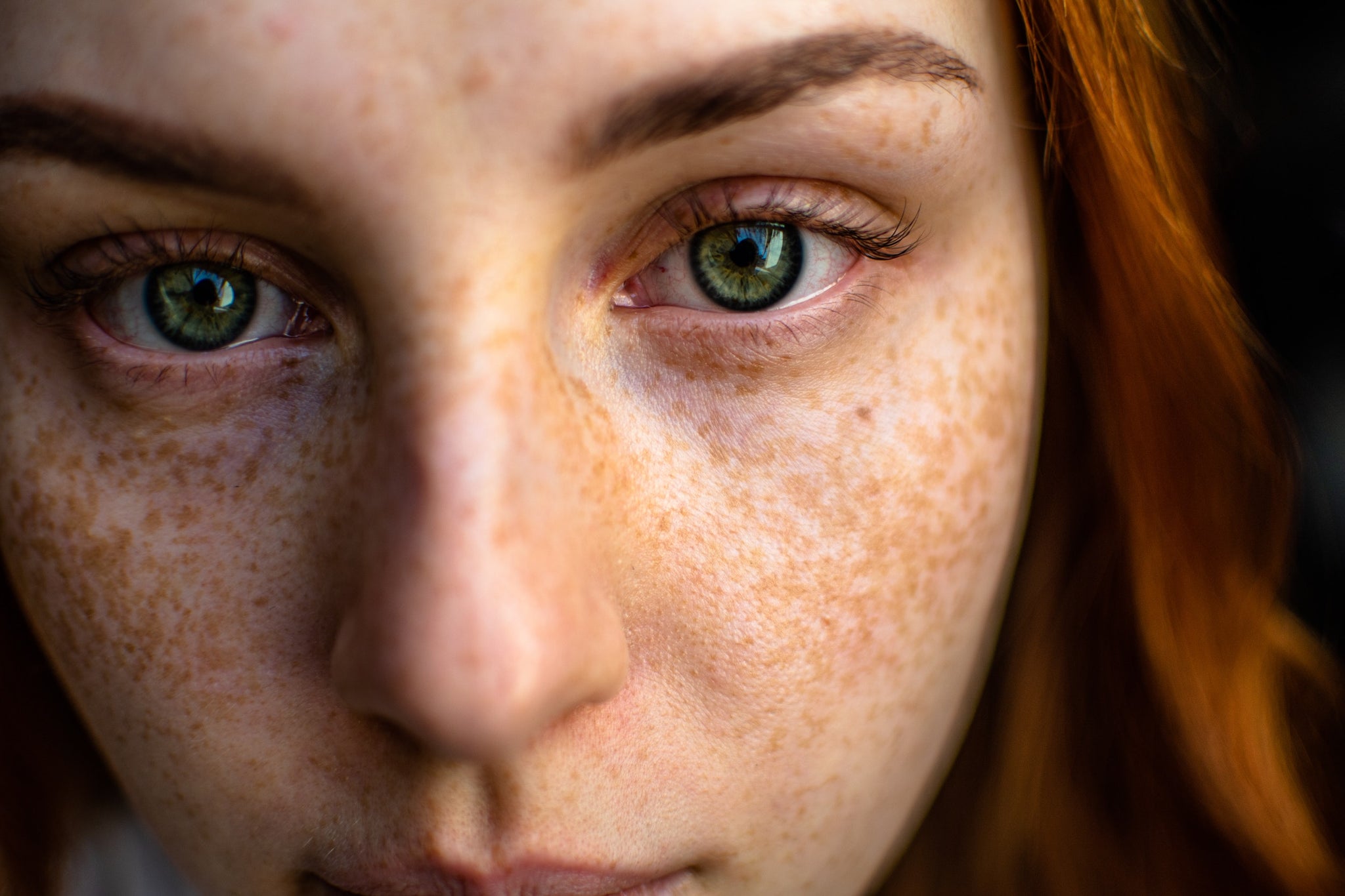 Close up of a woman with red hair and freckles