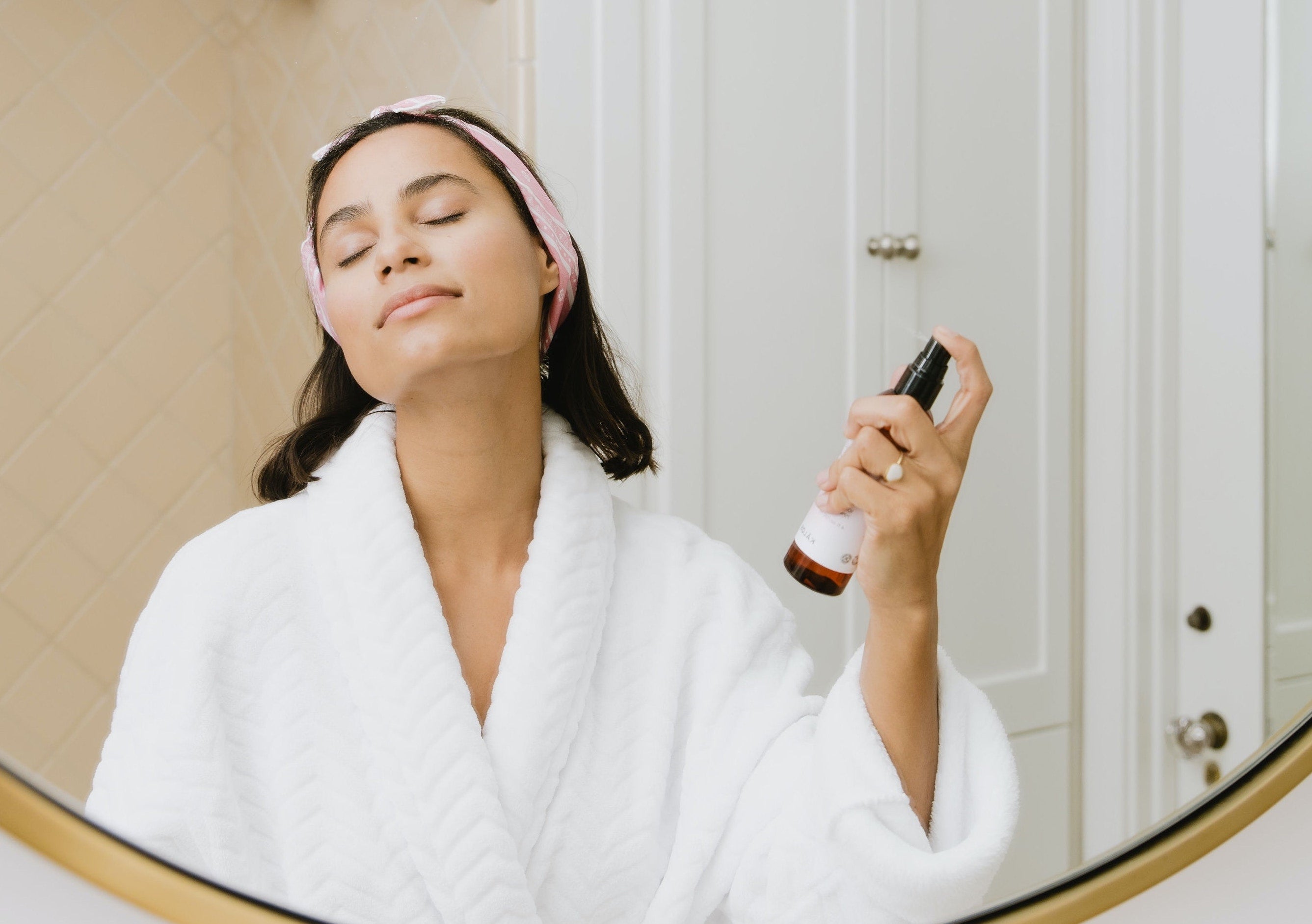 Woman spritzing toner on her face